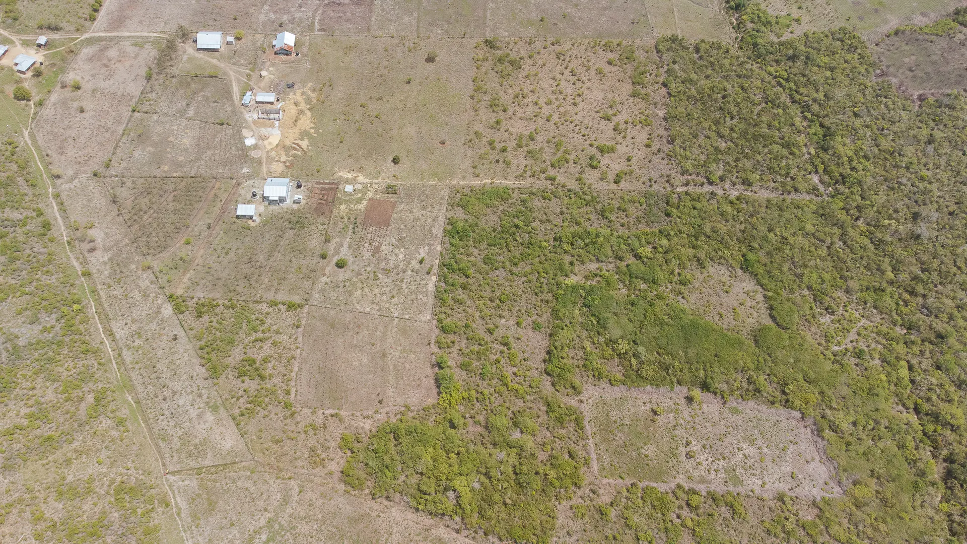 Aerial view showing the Keragita farm plots and surrounding coastal landscape